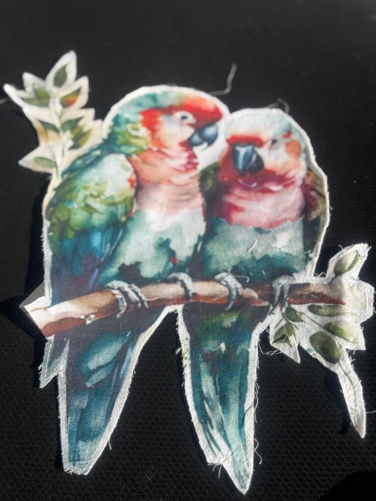 fabric patch featuring two parrots on a branch. embroidered patch or applique