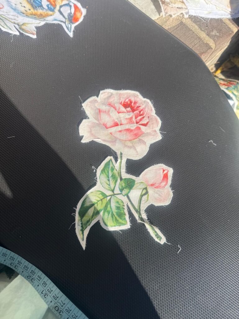 This is a delicate pink rose embroidered iron-on or sew-on applique patch