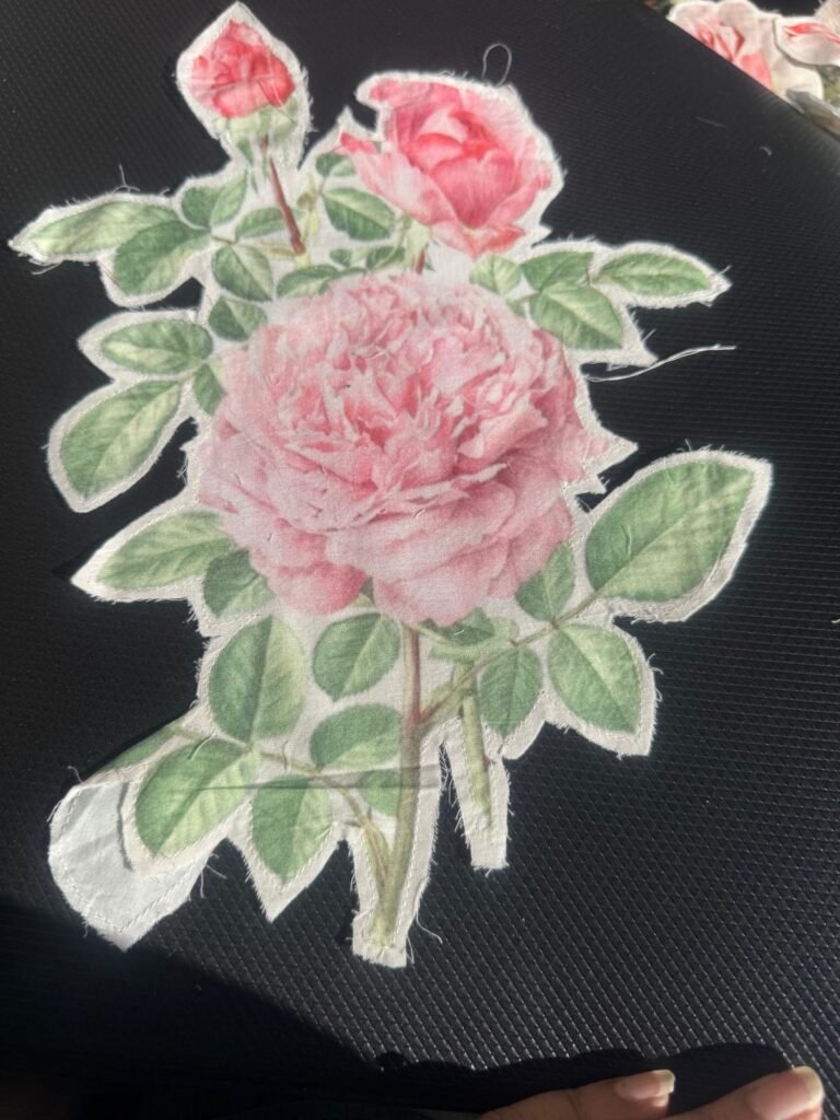 This is a delicate pink rose embroidered iron-on or sew-on applique patch