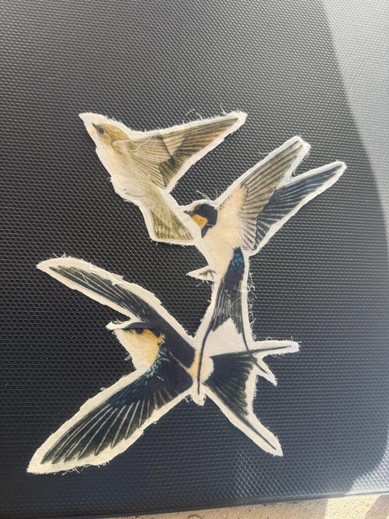 The image features cut-outs resembling barn swallows cotton patches embroidered patch or appliqué